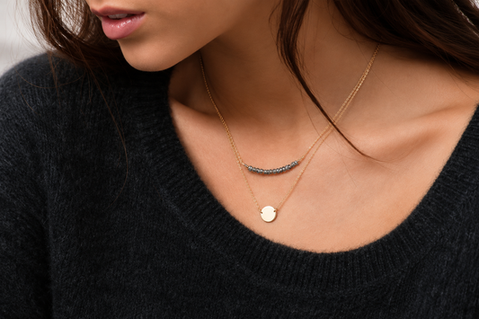 Dainty gold pendant name necklace styled with a crew neck dress, one of the best necklaces for a crew neck dress.