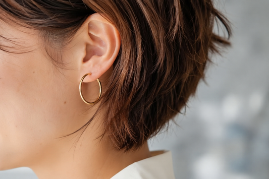 Woman with a pixie cut wearing the best earrings for short hair